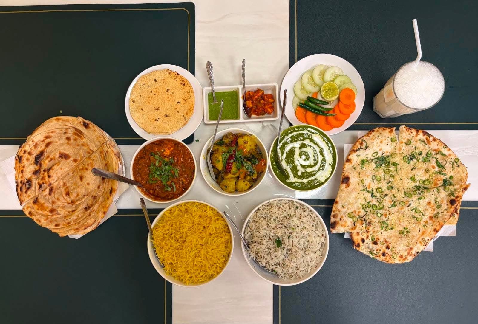 A full Indian spread โ naan, rice, curries and lassi at Indian Oven Indian Food